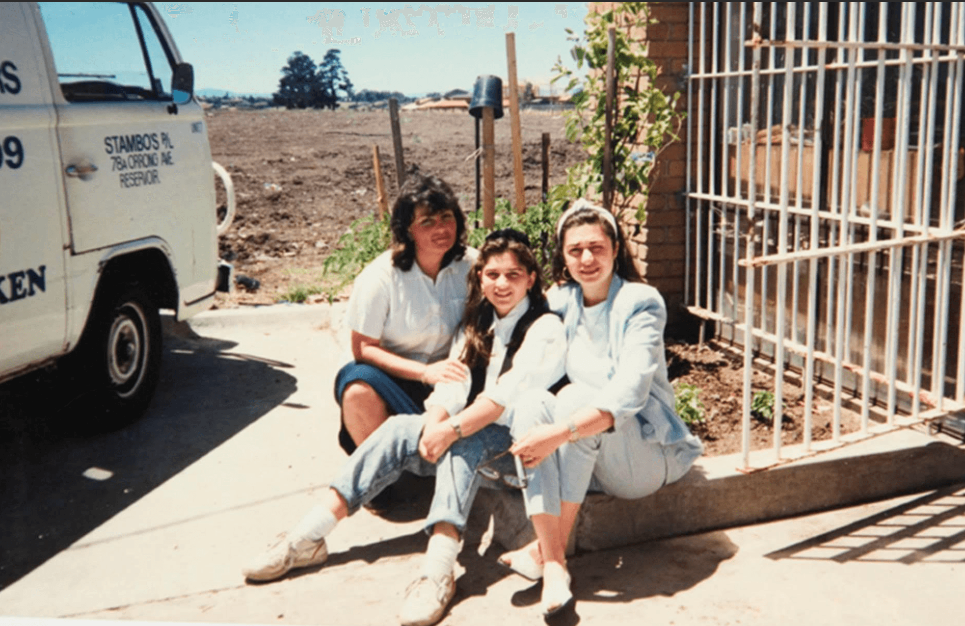 Olga and Anna Athanasopoulous with Kris Stamboulidis sitting in front of a Stambo's delivery van at the first fish premises